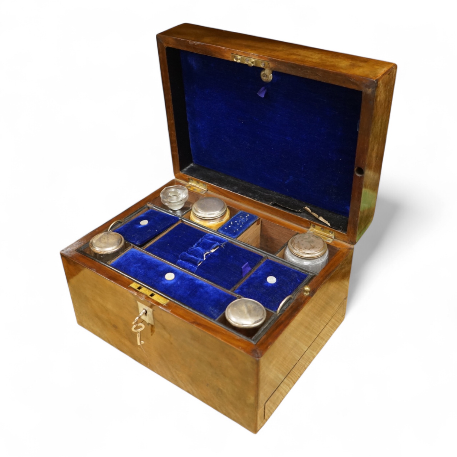 A 19th century walnut toilet box, fitted with glass and plate topped fittings, 27.5cm wide x 17cm high